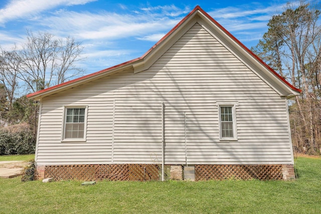 view of side of property with a yard