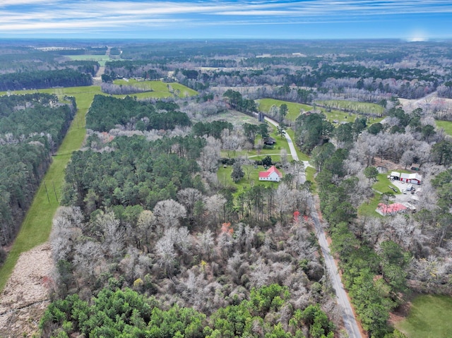 birds eye view of property with a view of trees