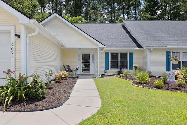 9091 Delancey Cir N, Charleston, SC 29406 - doorway to property featuring an attached garage, a yard, and a shingled roof