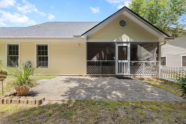9091 Delancey Cir N, Charleston, SC 29406 - back of property featuring a sunroom, a patio area, and roof with shingles