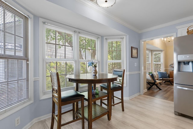 9091 Delancey Cir N, Charleston, SC 29406 - dining area featuring crown molding, light wood finished floors, and a chandelier