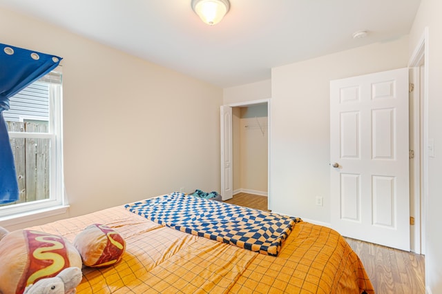 bedroom featuring baseboards and wood finished floors