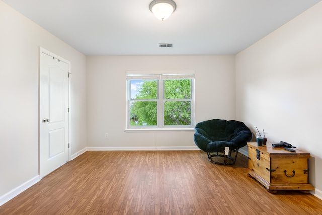 sitting room featuring baseboards, wood finished floors, and visible vents