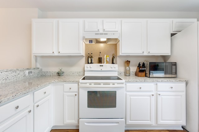 kitchen featuring white cabinets, white range with electric stovetop, light stone counters, stainless steel microwave, and under cabinet range hood