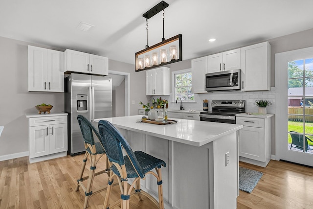 1391 Fairfield Ave, Charleston, SC 29407 - kitchen featuring stainless steel appliances, light wood-style floors, light countertops, white cabinetry, and recessed lighting