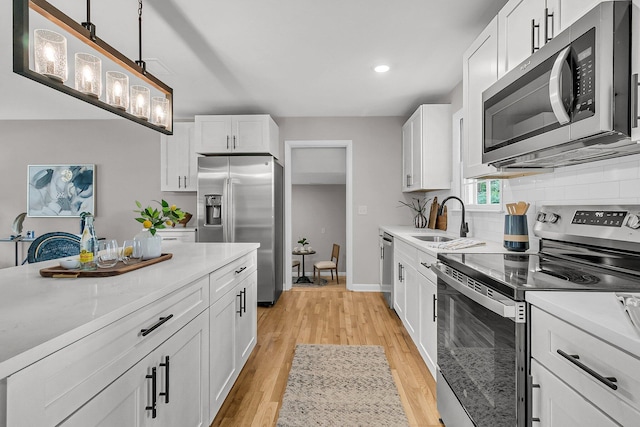 1391 Fairfield Ave, Charleston, SC 29407 - kitchen featuring stainless steel appliances, a sink, decorative backsplash, white cabinetry, and recessed lighting