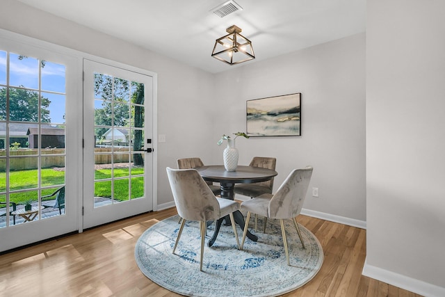 1391 Fairfield Ave, Charleston, SC 29407 - dining area with baseboards, a chandelier, and wood finished floors