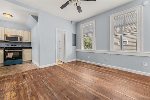 kitchen with ceiling fan, lofted ceiling, cream cabinetry, hardwood / wood-style flooring, and appliances with stainless steel finishes