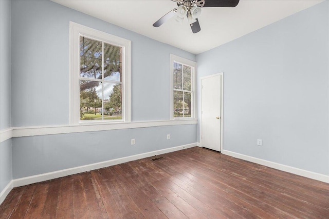 empty room featuring ceiling fan and dark wood-type flooring