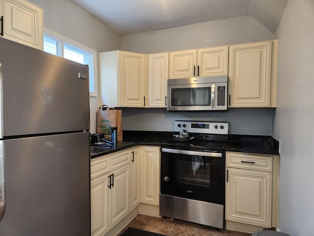 kitchen featuring appliances with stainless steel finishes and cream cabinetry