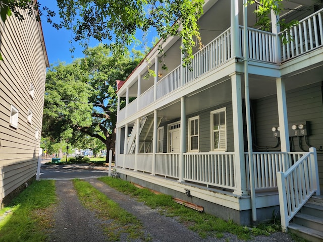 view of property exterior with a balcony and covered porch