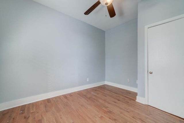 spare room with ceiling fan, vaulted ceiling, and light hardwood / wood-style floors