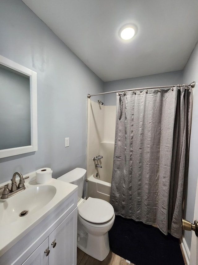 full bathroom with vanity, toilet, shower / bathtub combination with curtain, and hardwood / wood-style flooring