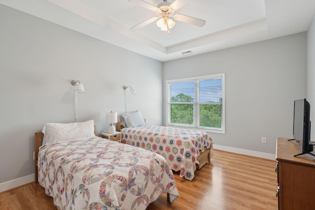 1984 Folly Rd Unit A310, Charleston, SC 29412 - bedroom featuring a raised ceiling, light wood finished floors, baseboards, and ceiling fan