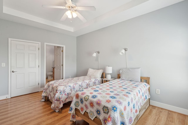 1984 Folly Rd Unit A310, Charleston, SC 29412 - bedroom featuring wood finished floors, a raised ceiling, baseboards, ceiling fan, and ensuite bath