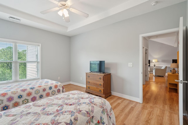 1984 Folly Rd Unit A310, Charleston, SC 29412 - bedroom with light wood-style flooring, baseboards, a tray ceiling, and a ceiling fan