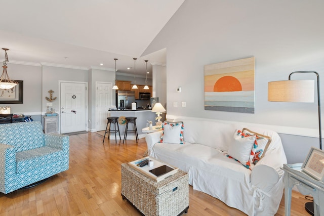 1984 Folly Rd Unit A310, Charleston, SC 29412 - living area with light wood-style floors, ornamental molding, and vaulted ceiling