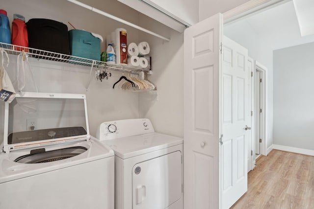 1984 Folly Rd Unit A310, Charleston, SC 29412 - washroom with washer and clothes dryer, light wood finished floors, and baseboards