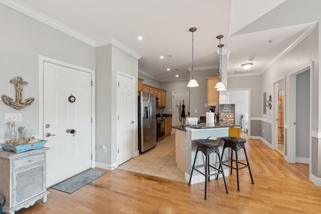 1984 Folly Rd Unit A310, Charleston, SC 29412 - kitchen featuring stainless steel fridge, a breakfast bar, light wood-type flooring, recessed lighting, and dark countertops
