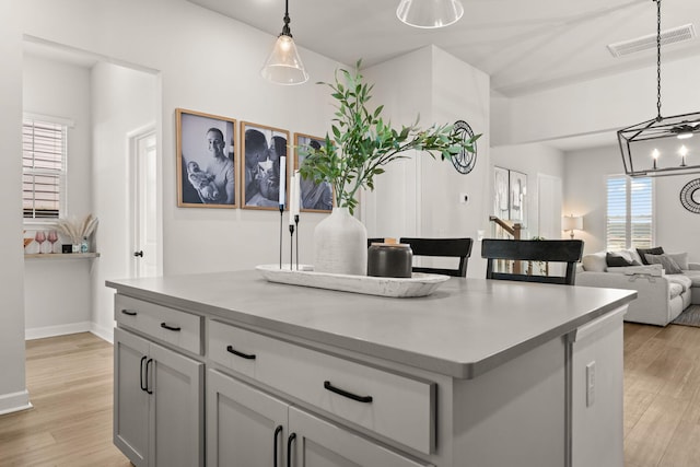 226 Midtown Ave, Summerville, SC 29486 - kitchen featuring light countertops, pendant lighting, light wood-style flooring, and a kitchen island