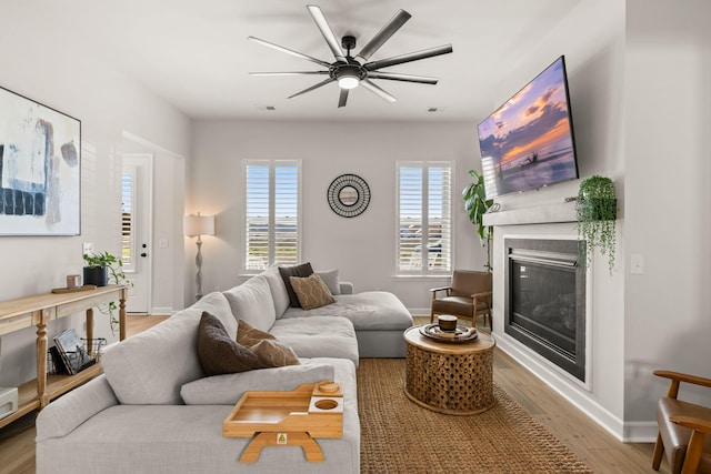 226 Midtown Ave, Summerville, SC 29486 - living area featuring wood finished floors, a glass covered fireplace, a ceiling fan, and baseboards