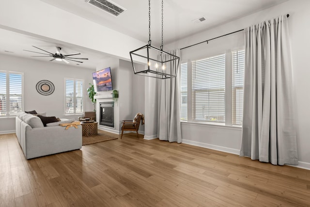 226 Midtown Ave, Summerville, SC 29486 - living room featuring baseboards, light wood-type flooring, and a chandelier