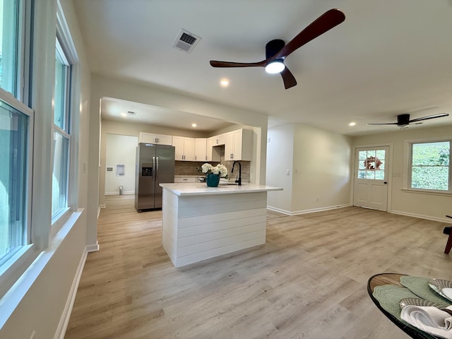 6086 Chisolm Rd, Johns Island, SC 29455 - kitchen featuring ceiling fan, stainless steel fridge, a sink, baseboards, and visible vents