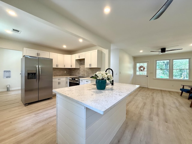 6086 Chisolm Rd, Johns Island, SC 29455 - kitchen with visible vents, a sink, baseboards, stainless steel appliances, and light wood-style flooring