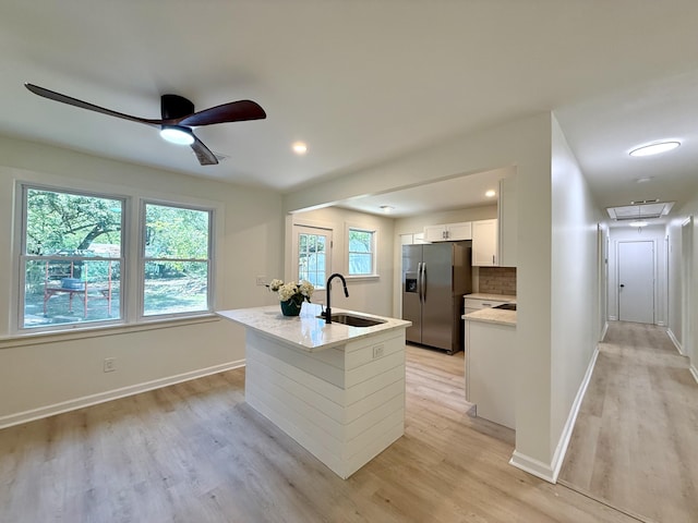 6086 Chisolm Rd, Johns Island, SC 29455 - kitchen with a ceiling fan, stainless steel refrigerator with ice dispenser, white cabinets, a sink, and light wood-style flooring