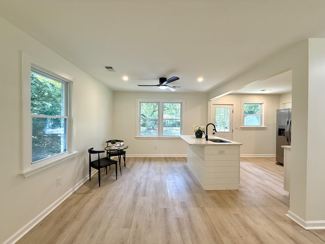 6086 Chisolm Rd, Johns Island, SC 29455 - kitchen featuring visible vents, a sink, stainless steel fridge with ice dispenser, and light wood-type flooring