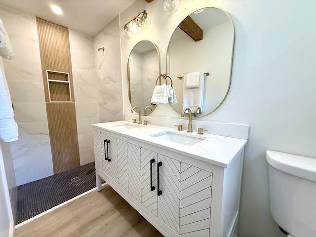 6086 Chisolm Rd, Johns Island, SC 29455 - bathroom featuring a sink, a tile shower, toilet, and wood finished floors