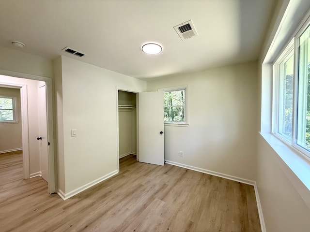 6086 Chisolm Rd, Johns Island, SC 29455 - unfurnished bedroom featuring visible vents, light wood-style flooring, and multiple windows