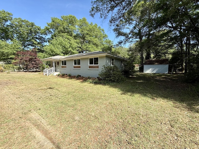 6086 Chisolm Rd, Johns Island, SC 29455 - exterior space with an outdoor structure, a yard, a shed, and brick siding