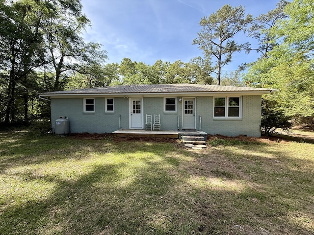 6086 Chisolm Rd, Johns Island, SC 29455 - exterior space featuring a lawn, brick siding, and metal roof