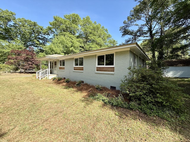 6086 Chisolm Rd, Johns Island, SC 29455 - view of home's exterior with brick siding, crawl space, and a yard