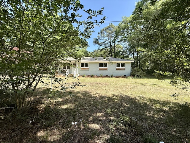 6086 Chisolm Rd, Johns Island, SC 29455 - view of front of home featuring metal roof, a front lawn, and crawl space