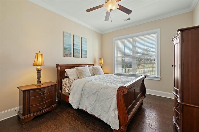 bedroom with visible vents, ornamental molding, dark wood finished floors, baseboards, and ceiling fan