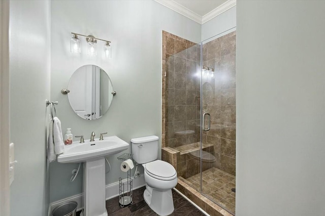 full bath with baseboards, toilet, ornamental molding, a stall shower, and a sink