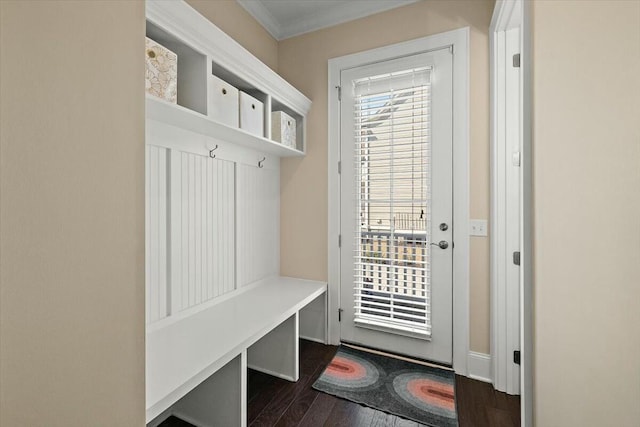 mudroom with a wealth of natural light, crown molding, and dark wood-type flooring