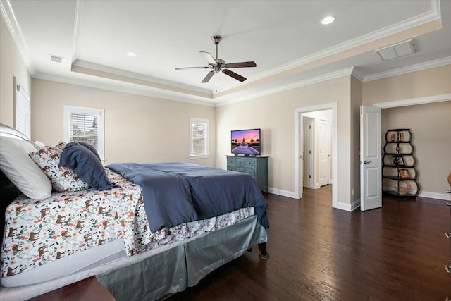 bedroom with a raised ceiling, multiple windows, and visible vents