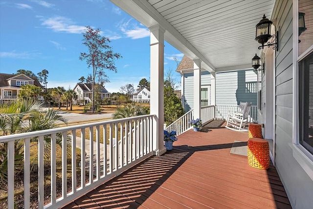 deck with covered porch and a residential view