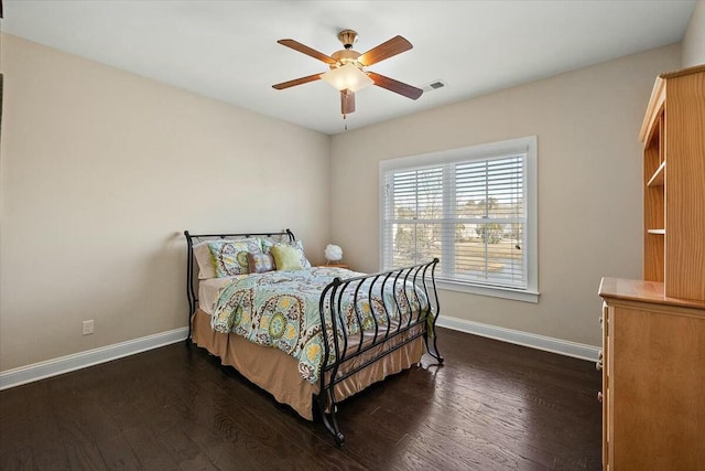 bedroom featuring visible vents, baseboards, ceiling fan, and dark wood-style flooring