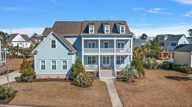 view of front facade featuring a balcony, covered porch, a front lawn, and roof with shingles