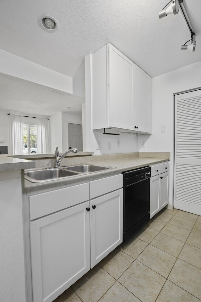 kitchen with light tile patterned flooring, sink, a textured ceiling, dishwasher, and white cabinets