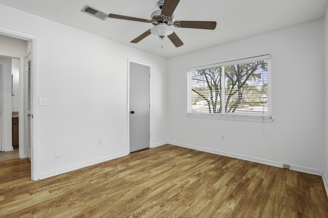 empty room featuring ceiling fan and light hardwood / wood-style flooring