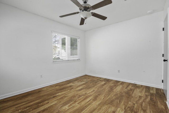 empty room with hardwood / wood-style floors and ceiling fan