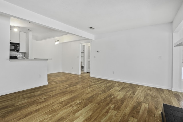 unfurnished living room with hardwood / wood-style floors