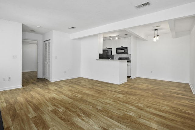 unfurnished living room featuring wood-type flooring