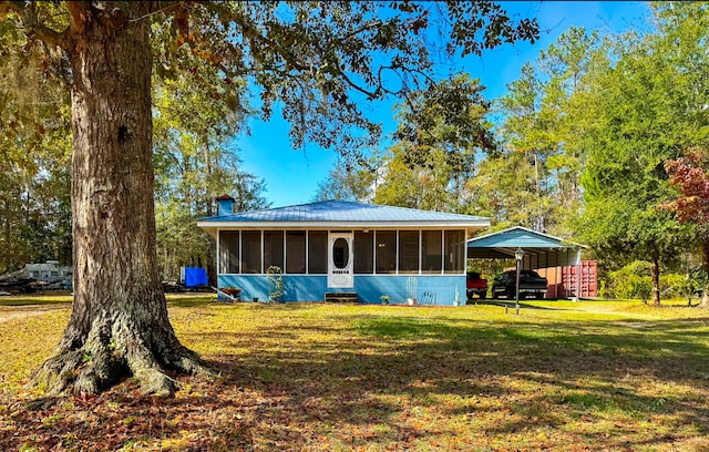 view of front of home featuring a front lawn and a sunroom