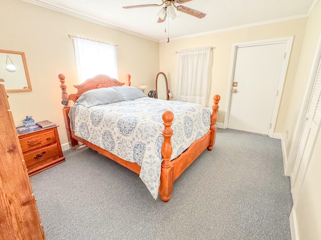 bedroom with ceiling fan, crown molding, and carpet floors